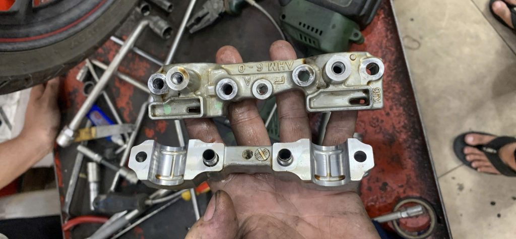 A worn-out cam chain guide removed from a Honda Winner during motorcycle maintenance in District 8.