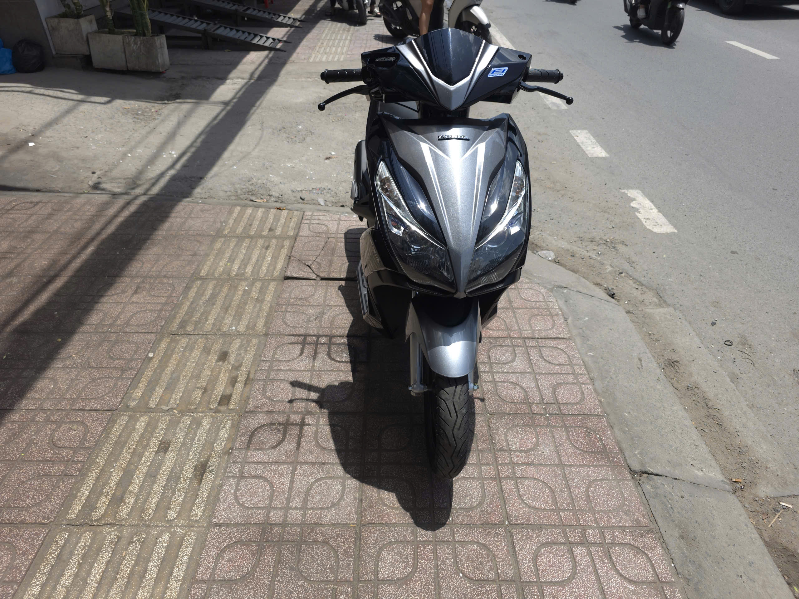 Front view of the restored Honda scooter, showcasing the new paint from the motorcycle overhaul service.